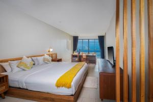 a bedroom with a bed and a view of the ocean at Dusit Buncha Koh Tao by Riya Group in Ko Tao