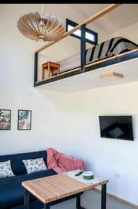 a living room with a blue couch and a wooden table at Minicasas in Villa Ciudad Parque +10 photos