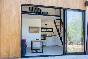 a room with a loft bed and a desk in a room at Minicasas cerca del rio Los Reartes in Villa Ciudad Parque