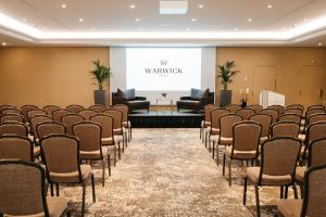 a conference room with chairs and a projection screen at Warwick Geneva in Geneva