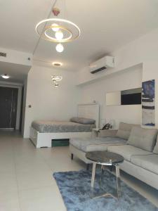 a living room with a couch and a bed at Aeon tower Davao exclusive studio unit in Davao City