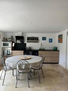 a kitchen and dining room with a table and chairs at Dbarka7 in Sète