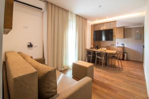 a living room with a couch and a dining room at Anna Suites Arpoador in Rio de Janeiro
