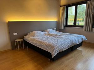 Rúm í herbergi á Welkomhoeve