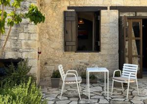 two chairs and a table in front of a building at Levanda House - Traditional House Vasa Koilaniou in Vasa Kilaniou