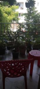 a bench sitting on a balcony with potted plants at Lulu's Bliss in Chennai