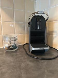 a toaster sitting on a counter next to a glass jar at No 12 Bridge Street - Town Centre Apartment in Westport