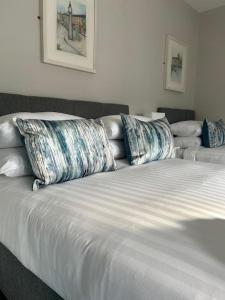 a bed with two pillows on top of it at No 12 Bridge Street - Town Centre Apartment in Westport