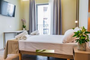 a large bed in a room with a window at Hotel Boccalino Sitges in Sitges +14 photos