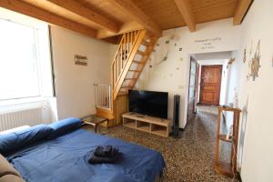 a living room with a blue bed and a staircase at Aria di Recco by PortofinoVacanze in Recco