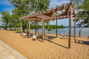a wooden pavilion on a beach next to the water at Four Corners RV Resort in Antioch