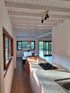 a kitchen with a stove and a counter top at Chalé Pedra Furada in Resende