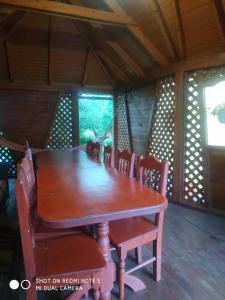 a wooden table and chairs in a room at У Галини in Lazeshchyna