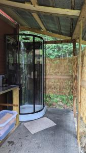 a glass shower in the middle of a house at Bell-tent Noord in Lappeenranta +10 photos