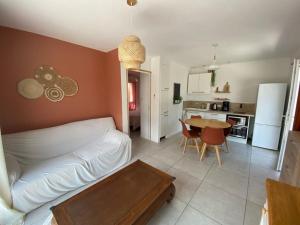 a living room with a couch and a table and a kitchen at Casa Pépé Brouilla in Brouilla