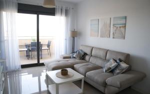 a living room with a couch and a table at Playa Marinsa Torre del Mar in Torre del Mar