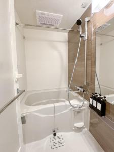 a white bathroom with a tub and a shower at Triphome Higahsi Shinjuku Brand New in Tokyo +38 photos