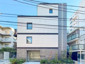 a facade of a building with lots of wires at Triphome Higahsi Shinjuku Brand New in Tokyo