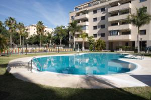 a large swimming pool in front of a building at Playa Marinsa Torre del Mar in Torre del Mar