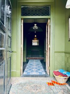 a hallway with green walls and a basket on the floor at Greystonedale Mansion and House, Haltwhistle in Haltwhistle