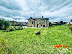 an old house in the middle of a field at Greystonedale Mansion and House, Haltwhistle in Haltwhistle