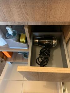 a hairdryer in a wooden drawer with a hair dryer at Charming Cozy Retreat - Terrace & Private Balcony in Coimbra