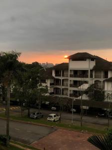 an apartment building with cars parked in a parking lot at Casa Blanca R2 in Cyberjaya