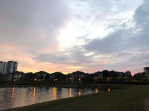a body of water with buildings and a cloudy sky at Casa Blanca R2 in Cyberjaya