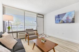 una sala de estar con un sofá y una mesa en Mins from Disney Gym Pool Parking Pet Friendly, en Kissimmee