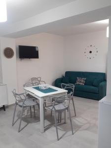 a living room with a table and chairs and a couch at NAHAR HOME in Naro