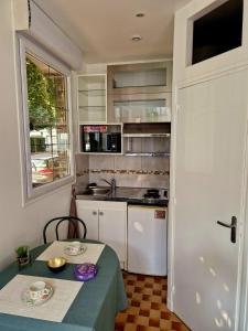 a kitchen with a table and a table and a window at Studio Porte de Versailles in Vanves