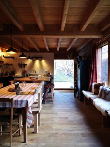 a dining room with a table and a large window at L'Escale Pyrénéenne in Melles