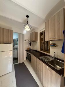 a kitchen with wooden cabinets and a white refrigerator at Casa Giampà in Satriano