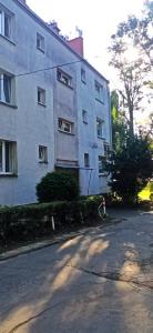 a person walking in front of a building at Apartament Lyszcze 7 Centrum Parking Balkon Blisko rynku Spokojna okolica in Tarnowskie Góry