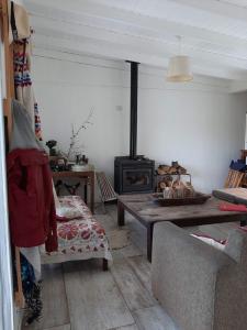 a living room with a couch and a wood stove at Chacra en Cañuelas in Cañuelas