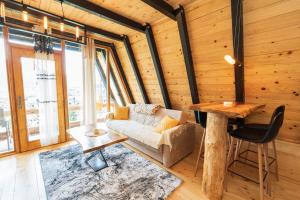 a living room with a couch and a table at Eka's Village in Plav