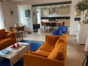 a living room with a couch and a dining room at La biche in Bonnes