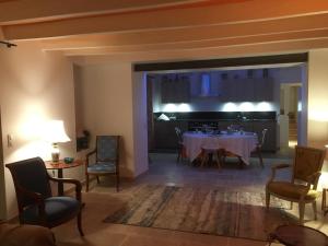 a dining room with a table and chairs and a kitchen at La biche in Bonnes +15 photos