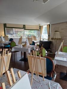 a room with chairs and tables and a room with windows at Wild Cherry Apartments in Saints Constantine and Helena