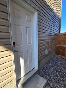 a door on the side of a building at Cozy New 1 bed basement suite in Edmonton