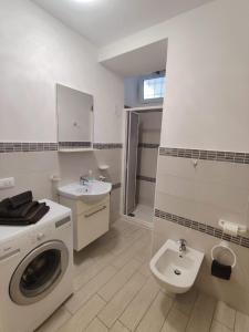 a bathroom with a washing machine and a sink at le case di nonna Piera in Lecco +24 photos