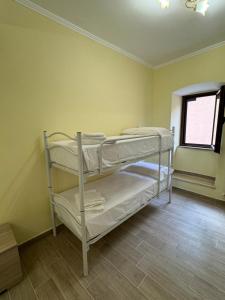 two bunk beds in a room with a window at Da Nonna Maria - Belvedere in Celano
