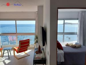 a bedroom with a bed and a view of the ocean at MarMédano Apartamento 3 in El Médano +4 photos