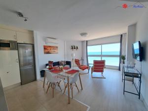 a kitchen and living room with a table and chairs at MarMédano Apartamento 3 in El Médano