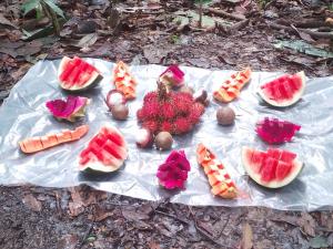 a group of fruit and vegetables on a table at Ustin Nagoya Bukit Lawang Orangutan Trekking & transport You can only stay at the hotel if you book your trekking with us in Bukit Lawang