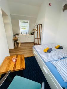 a bedroom with a bed and a wooden table at Apartmán U Hvězdáře in Křišťanovice
