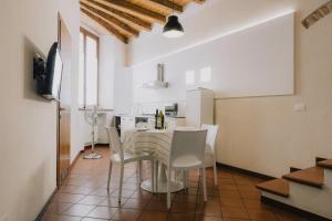 a kitchen and dining room with a table and chairs at Cavour Luxury Apartments in Verona