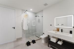 a bathroom with a shower and a toilet and a sink at Luxe Apartment in Prime Location in Fort Lauderdale +46 photos