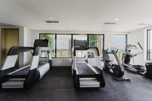 a gym with two treadmills and two exercise bikes at Luxe Apartment in Prime Location in Fort Lauderdale