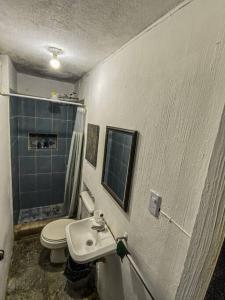a bathroom with a white toilet and a sink at Casa San Bartolo in Antigua Guatemala